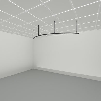 Zone A quarter arc dividing curtain track suspended from a grid ceiling on drop tubes