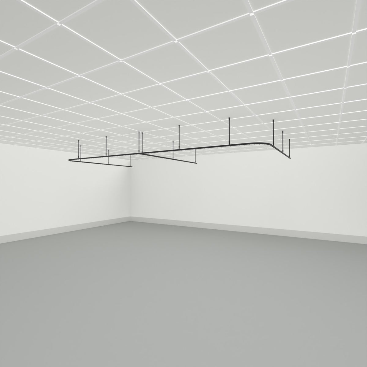 Zone E dividing curtain track suspended from a grid ceiling on drop tubes