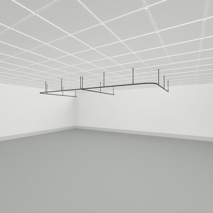 Zone E dividing curtain track suspended from a grid ceiling on drop tubes