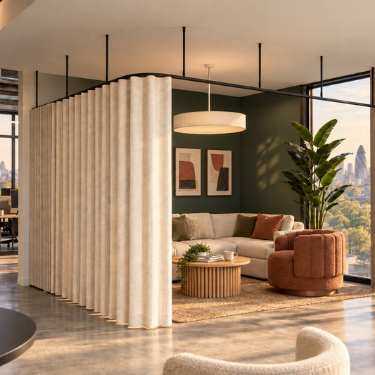 Zone L dividing curtain track with a wave curtain, suspended on drop tubes round a corner lounge in an office