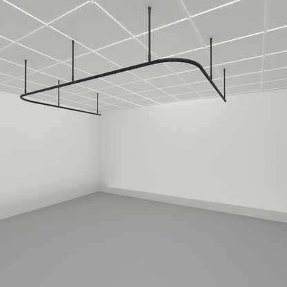Zone U dividing curtain track suspended from a grid ceiling on drop tubes